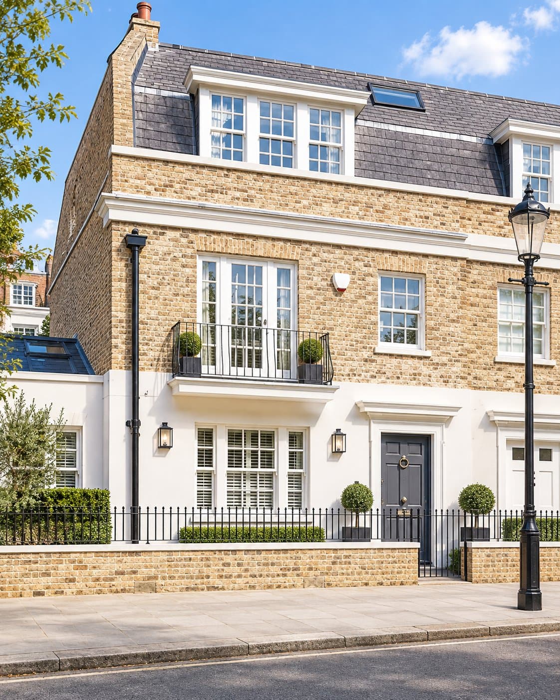 Street elevation of the town house at Markham Square, Chelsea: yellow stock brick over a white rendered ground floor, with a mansard roof